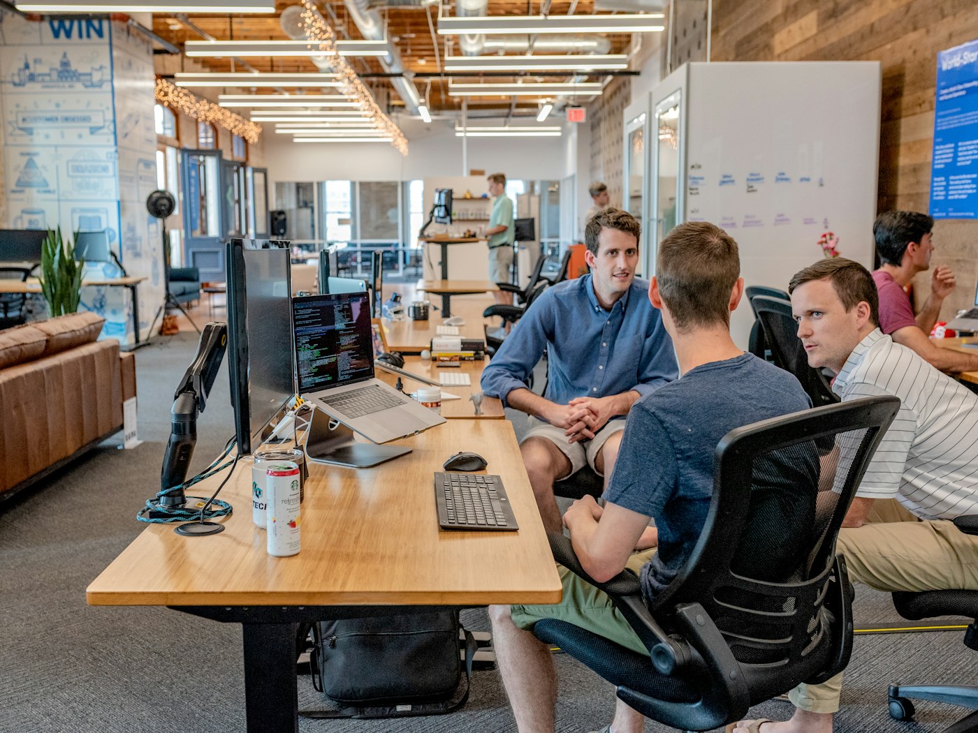 Team collaborating around a laptop in an office